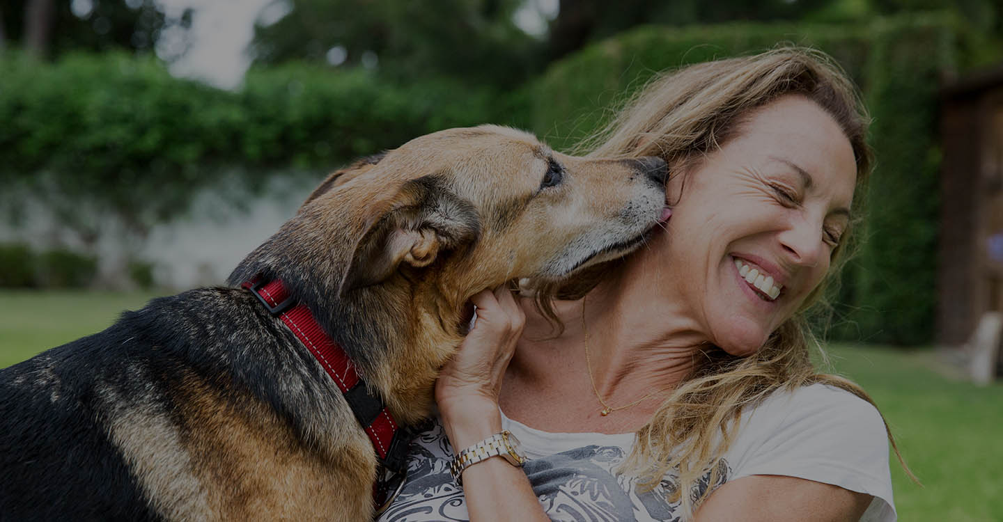 Woman playing with dog for brain health