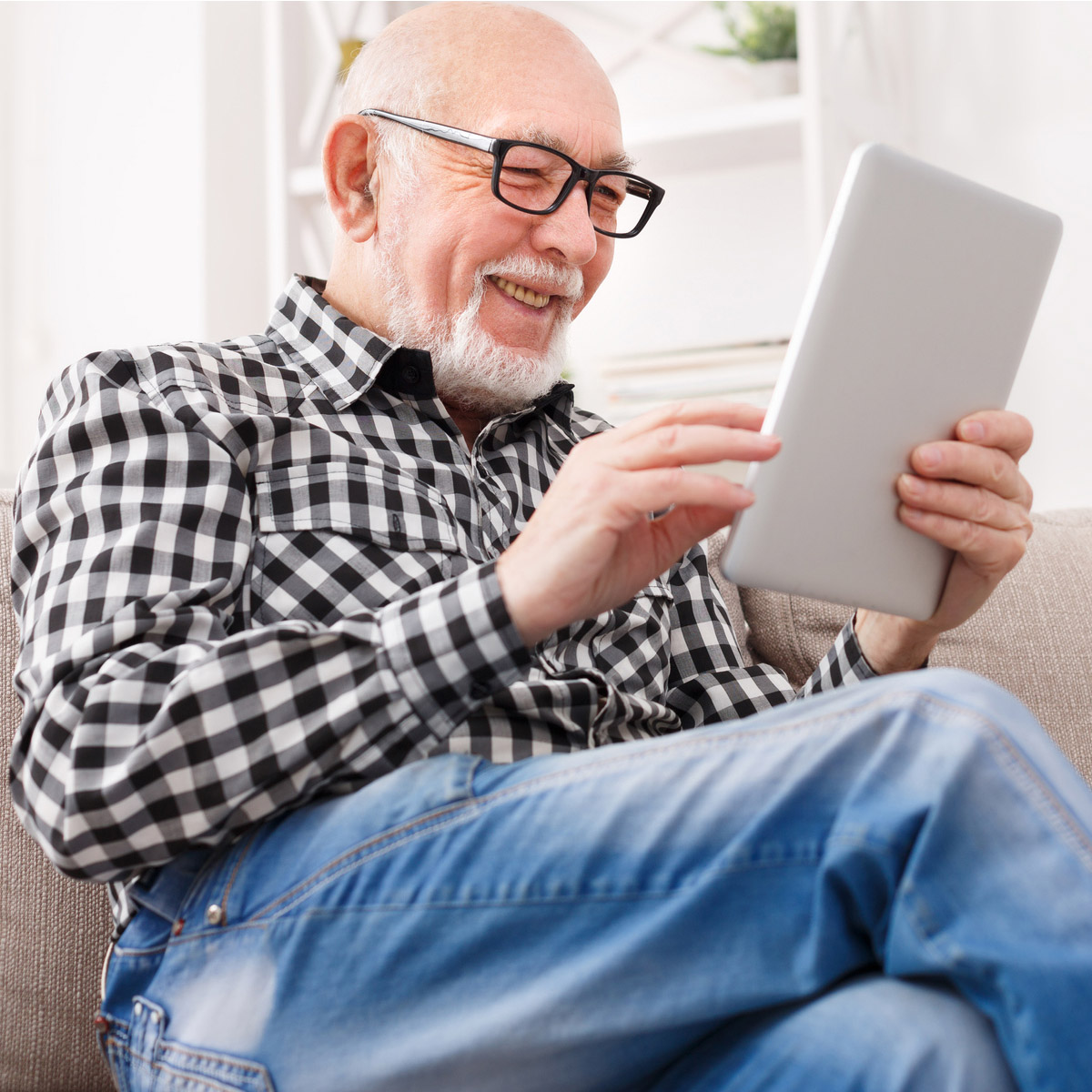 older man reading a tablet