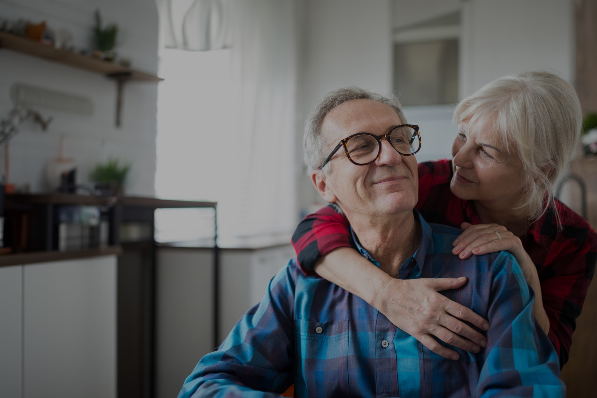 Older woman putting her arm around her husband.