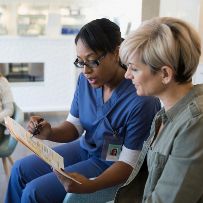 Neurological surgeon going over records with Florida Hospital patient