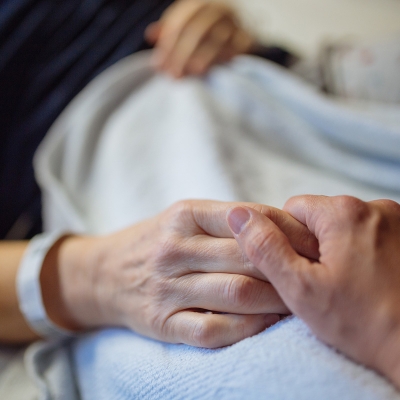 Brain patient holding hands with relative