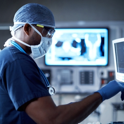 Physicians wearing mask using medical equipment